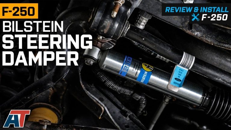 A high-quality steering stabilizer installed on the front suspension of a Ford F250 truck.