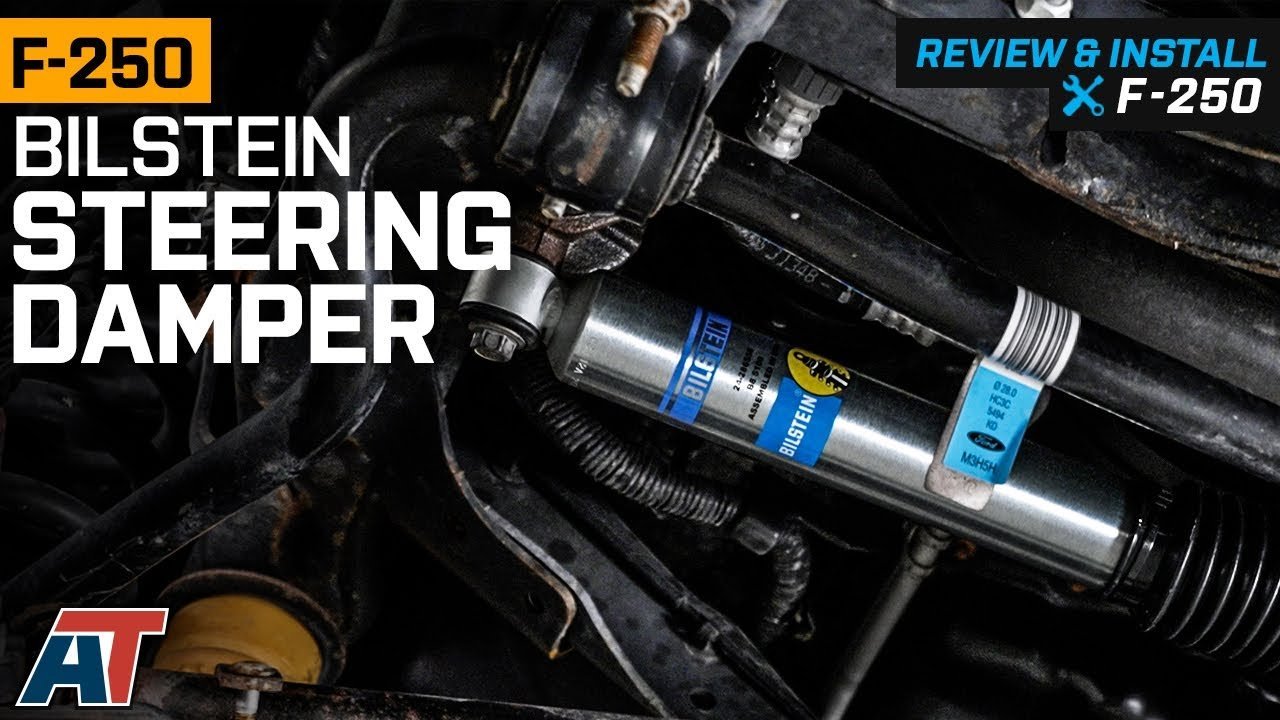 A high-quality steering stabilizer installed on the front suspension of a Ford F250 truck.